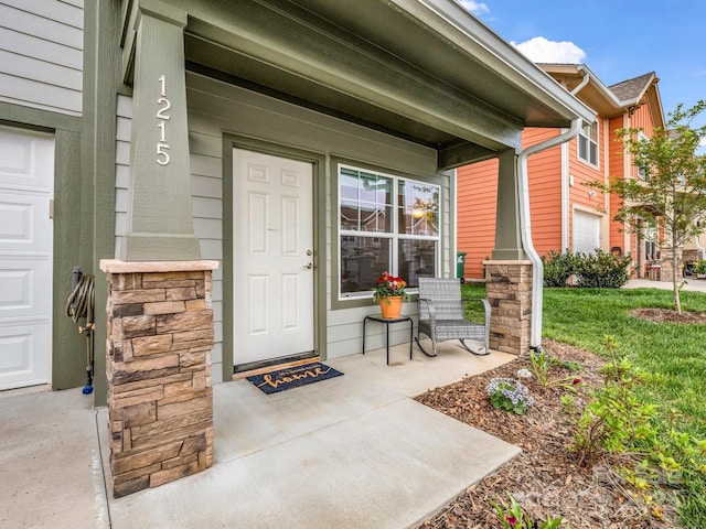 entrance to property with covered porch and stone siding
