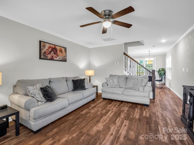 living room featuring crown molding, stairs, baseboards, visible vents, and dark wood-style floors