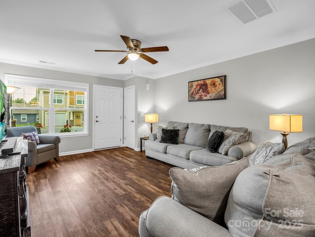 living area with ceiling fan, baseboards, wood finished floors, visible vents, and ornamental molding
