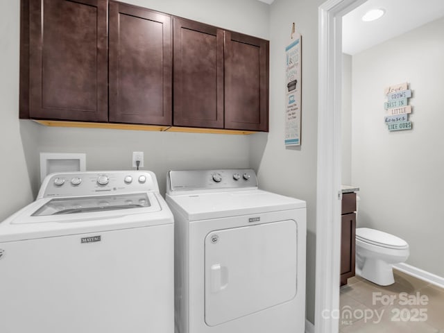 washroom with baseboards, separate washer and dryer, laundry area, and light tile patterned floors