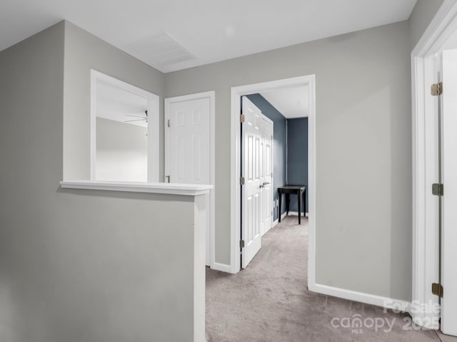 hall with carpet floors and baseboards