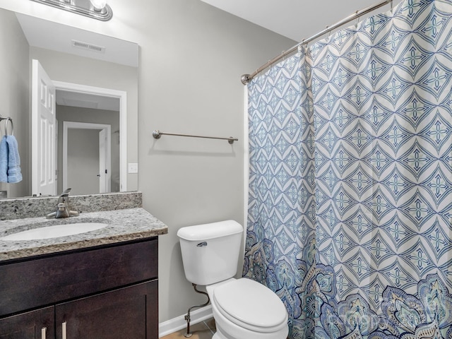 bathroom with visible vents, vanity, curtained shower, toilet, and baseboards