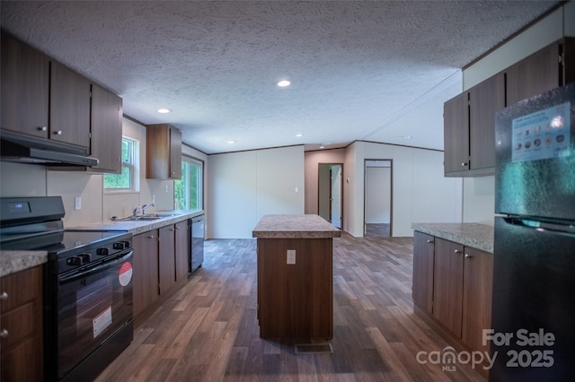 kitchen featuring under cabinet range hood, dark wood-type flooring, black appliances, and a center island