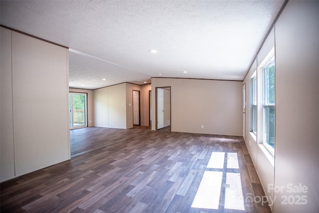 unfurnished living room with recessed lighting, a textured ceiling, and wood finished floors