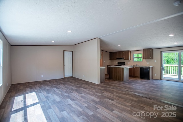 unfurnished living room with recessed lighting, a textured ceiling, and dark wood finished floors