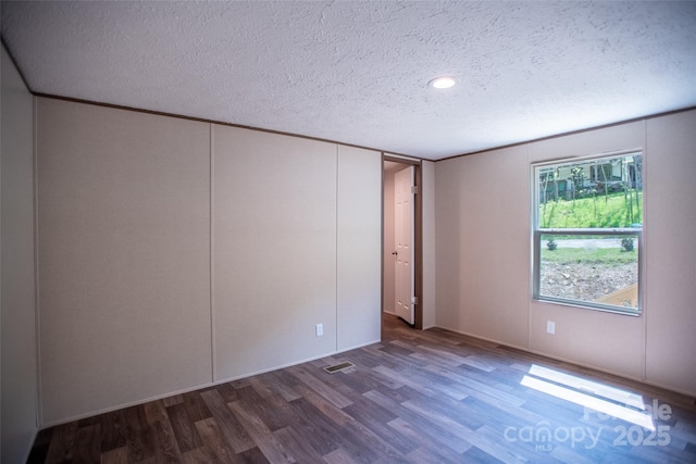 unfurnished bedroom with recessed lighting, a textured ceiling, and wood finished floors