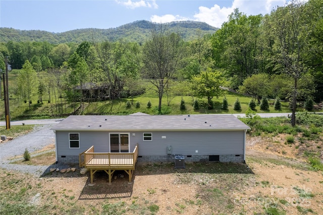 back of house featuring central AC unit, a deck with mountain view, and crawl space