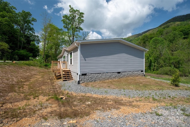 view of side of property with crawl space