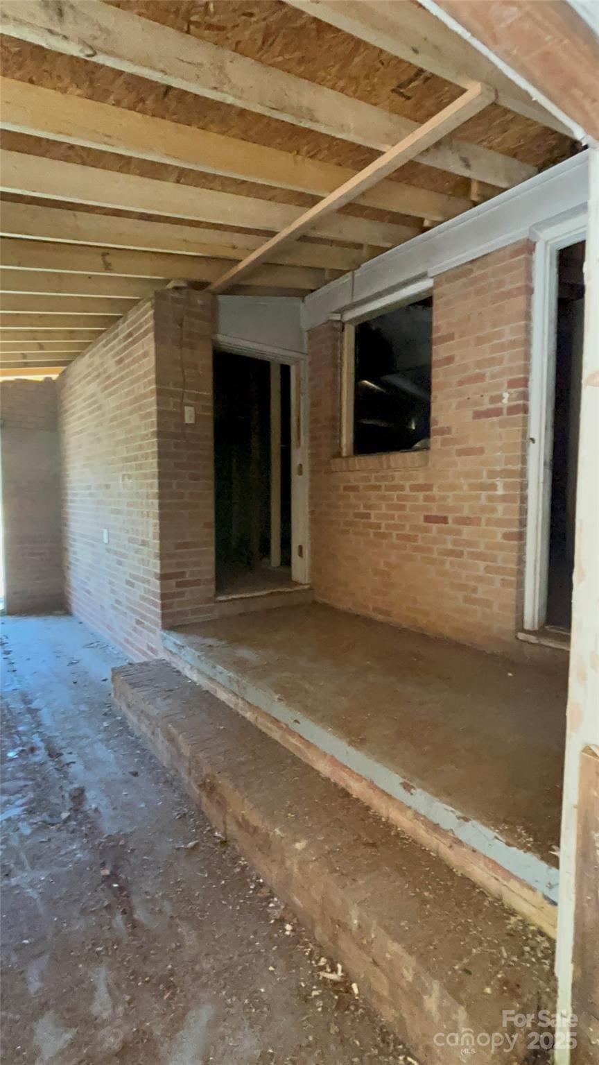 interior space featuring brick wall