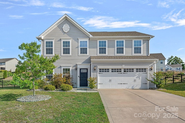 view of front of home featuring a garage, fence, driveway, and a front yard