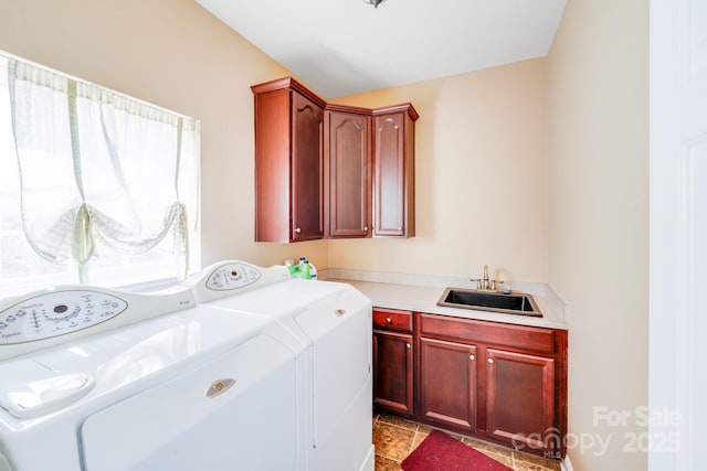 laundry room featuring a sink, cabinet space, and independent washer and dryer