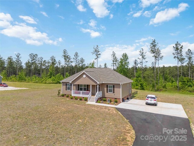3015 Great Falls Highway, Chester, SC 29014 - view of front facade featuring covered porch, a forest view, crawl space, and a front lawn