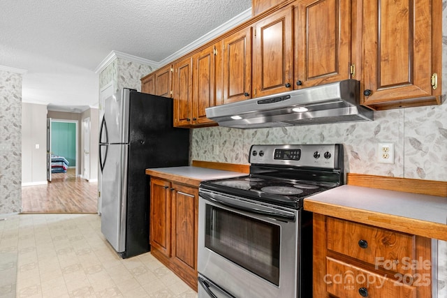 2521 Melvin Propst Dr, Morganton, NC 28655 - kitchen featuring under cabinet range hood, stainless steel appliances, ornamental molding, brown cabinetry, and a textured ceiling