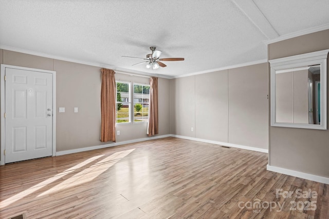 2521 Melvin Propst Dr, Morganton, NC 28655 - unfurnished living room with a ceiling fan, light wood-style floors, a textured ceiling, baseboards, and crown molding