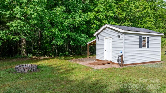 2521 Melvin Propst Dr, Morganton, NC 28655 - view of shed featuring an outdoor fire pit and a forest view