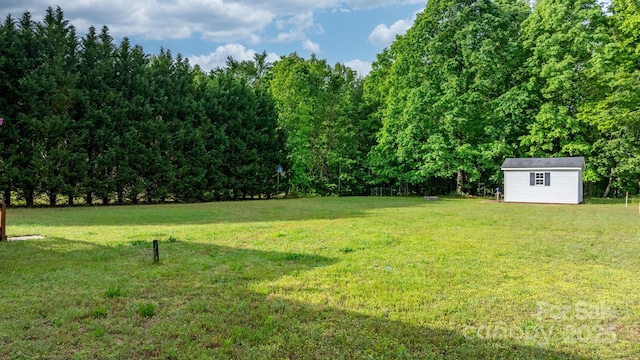 2521 Melvin Propst Dr, Morganton, NC 28655 - view of green lawn with an outdoor structure, a storage shed, and a view of trees