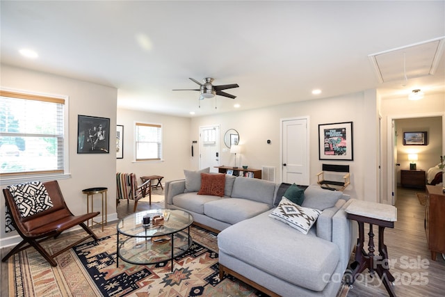 living area with a ceiling fan, attic access, visible vents, light wood-style floors, and recessed lighting