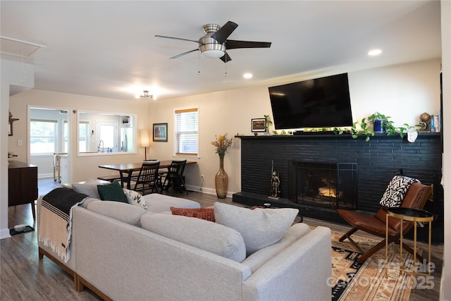 living room with plenty of natural light, attic access, baseboards, and ceiling fan