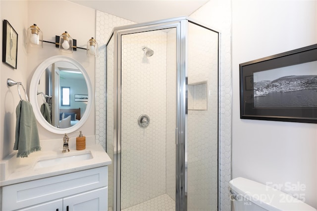 full bath featuring vanity, a shower stall, and toilet