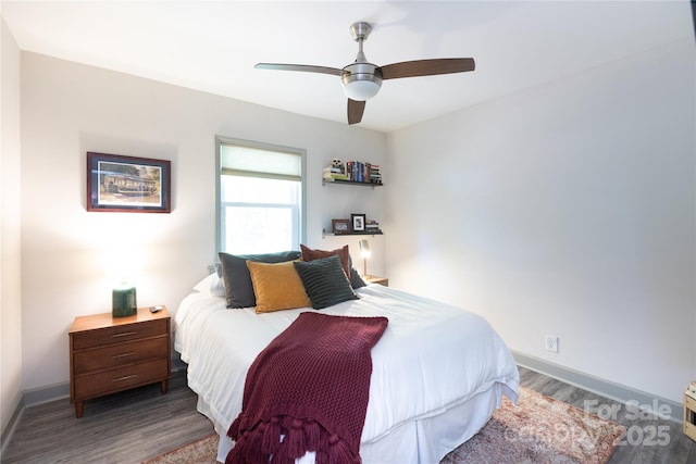 bedroom featuring baseboards, ceiling fan, and wood finished floors