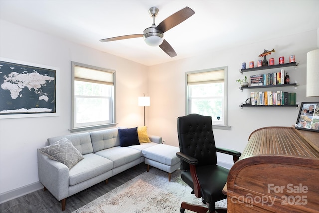 office space featuring baseboards, a ceiling fan, wood finished floors, and a healthy amount of sunlight