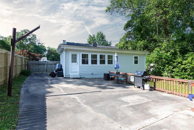 back of property featuring fence and a patio area