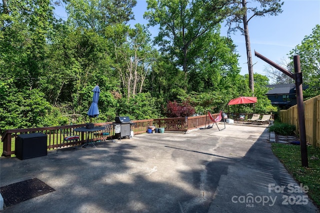view of patio featuring fence and grilling area