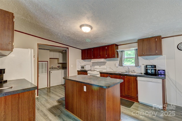 101 J M Ln, Lawndale, NC 28090 - kitchen featuring washing machine and clothes dryer, dark countertops, a sink, light wood-style floors, and white appliances