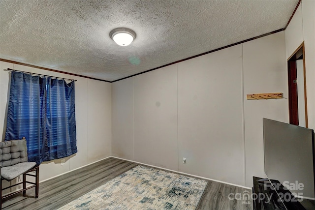 101 J M Ln, Lawndale, NC 28090 - unfurnished room featuring a textured ceiling, ornamental molding, wood finished floors, and a decorative wall