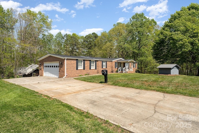 5013 Friendship Circle Rd, East Bend, NC 27018 - ranch-style home with brick siding, a garage, concrete driveway, a front lawn, and a shed