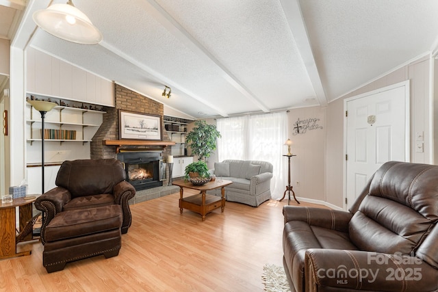 5013 Friendship Circle Rd, East Bend, NC 27018 - living area featuring light wood-style flooring, a brick fireplace, and a textured ceiling