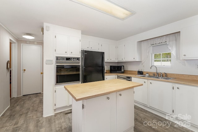5013 Friendship Circle Rd, East Bend, NC 27018 - kitchen featuring black appliances, white cabinetry, wood finished floors, and a center island