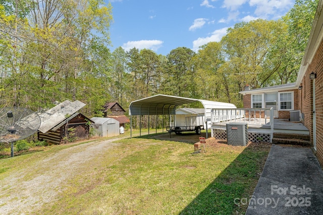 5013 Friendship Circle Rd, East Bend, NC 27018 - view of green lawn with a storage shed, a wooden deck, a carport, and dirt driveway