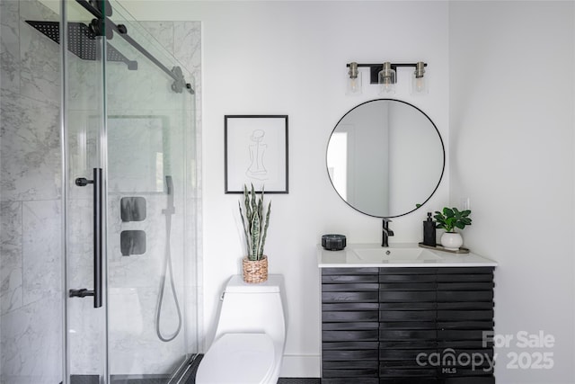 bathroom with vanity, a shower stall, and toilet