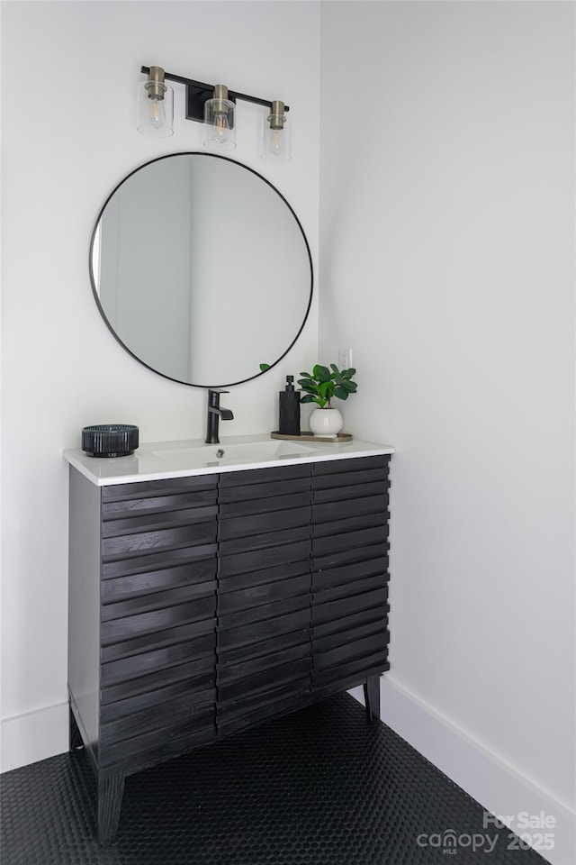 bathroom with baseboards, tile patterned floors, and vanity
