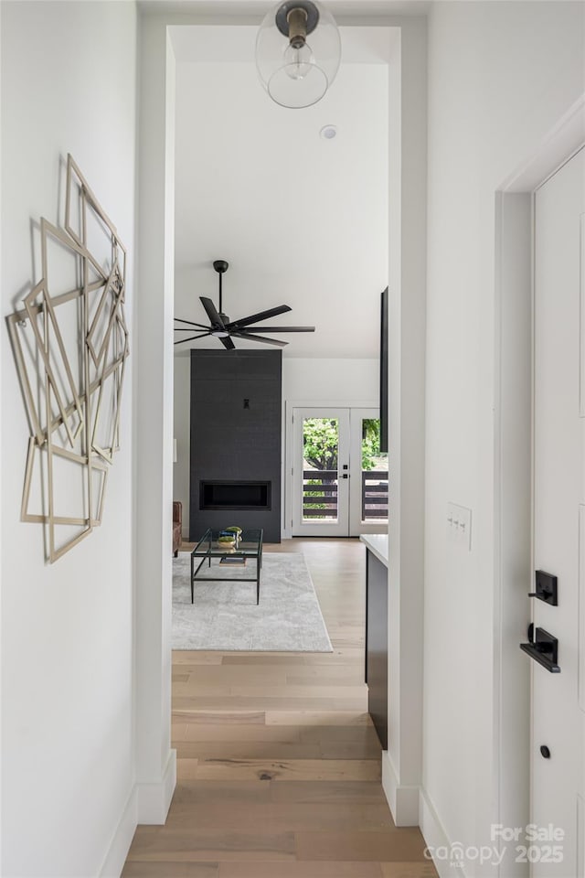 hall featuring baseboards and wood finished floors