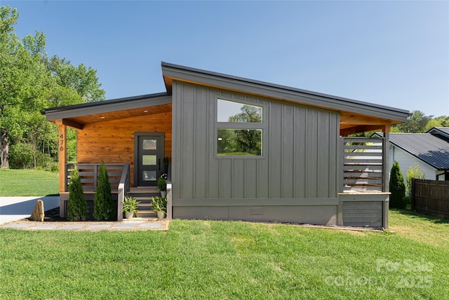 exterior space featuring covered porch and fence