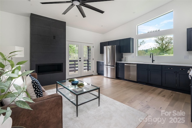 476 Upper Grassy Branch Rd, Asheville, NC 28805 - living area with ceiling fan, light wood finished floors, high vaulted ceiling, french doors, and a large fireplace