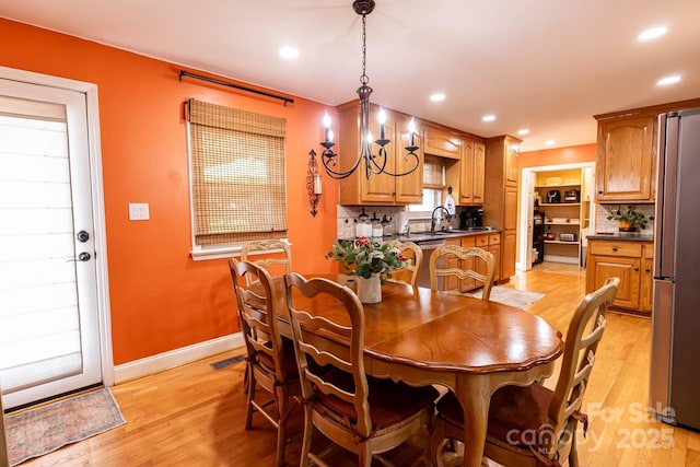 dining space with visible vents, baseboards, recessed lighting, a chandelier, and light wood-style flooring