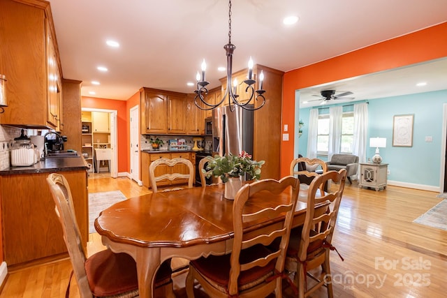 dining room with recessed lighting, baseboards, light wood finished floors, and ceiling fan with notable chandelier