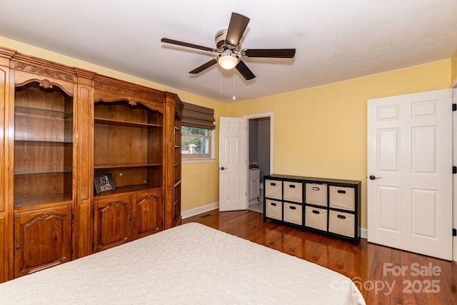 bedroom with baseboards, ceiling fan, and dark wood-style flooring