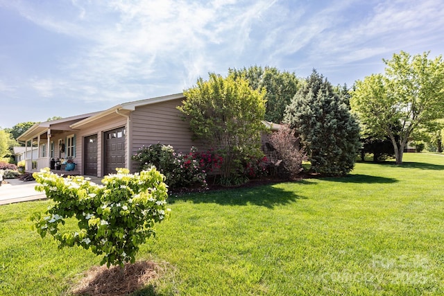 view of property exterior featuring a garage and a yard