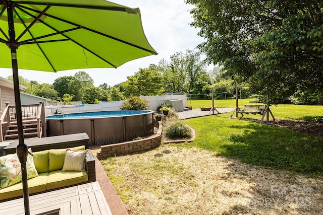 view of yard featuring a fenced in pool, outdoor lounge area, and a deck