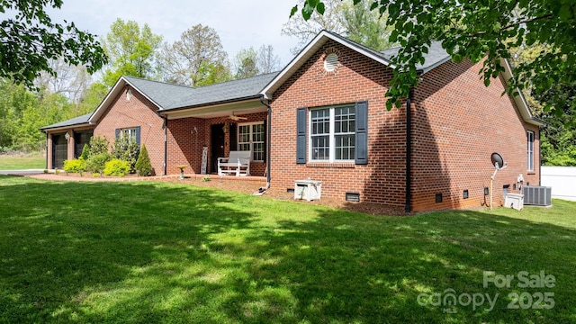 view of front of property featuring brick siding, crawl space, central AC unit, and a front lawn