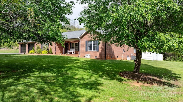 view of front of home with a garage, a front lawn, brick siding, crawl space, and a porch