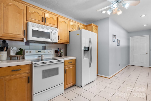 kitchen featuring ceiling fan, light tile patterned flooring, white appliances, and tasteful backsplash