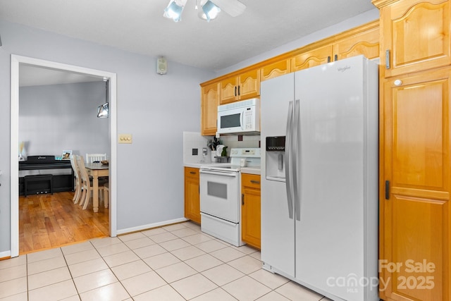 kitchen with white appliances, baseboards, ceiling fan, light countertops, and light tile patterned floors