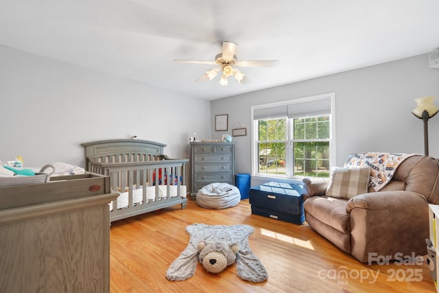 bedroom with a ceiling fan and wood finished floors