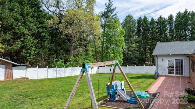 view of yard with a fenced backyard and a playground