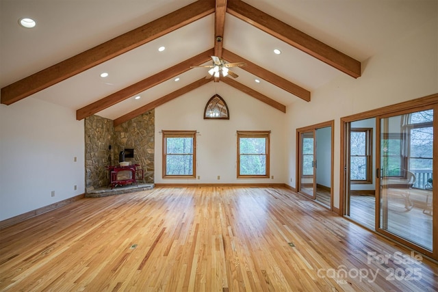unfurnished living room featuring light wood finished floors, beam ceiling, and ceiling fan